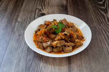 Roasted lamb liver with onions and tomatoes.