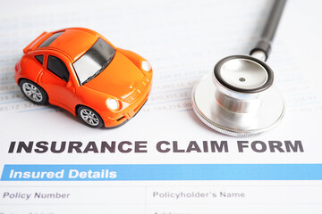 Stethoscope on Insurance claim accident car form, Car loan, insurance and leasing time concepts.