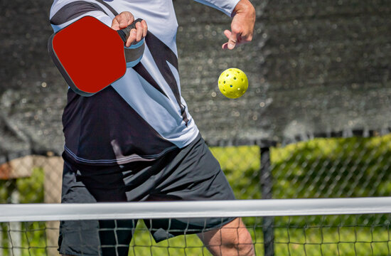 Male pickleball player about to hit a volley shot using a forehand