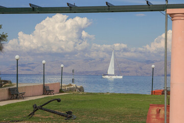 Sailboat in the calm sea framed by a wooden gazebo - 567418959