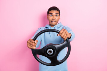 Photo of young nervous stressed man bite lips steering wheel forgot driver license while policeman check insurance isolated on pink color background