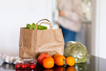 fresh food in a bag on the table, in the kitchen, space for text