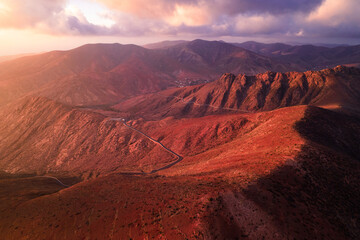 Fototapeta na wymiar Volcanic mountains and red canyon at sunset (aerial view)
