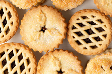 Background of all butter mince pies on white.