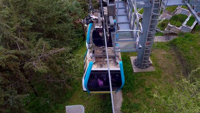 Footage of the famous aerial tram in Eyupsultan district of Istanbul. Two cabins are going downhill over the cemetery with views of golden horn. Concept image for cable car as method of transportation