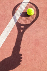 Tennis ball and racket on the court