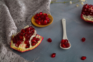 Red juice pomegranate composition on green background