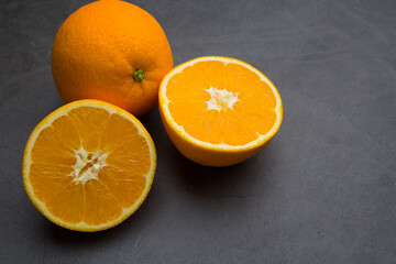Fresh ripe orange on dark stone background. Top view
