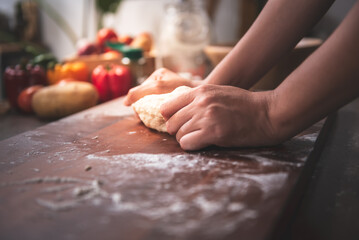 person using hand knead the pizza dough. to kitchen and pizza homemade concept.