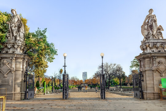 Barcelona, Spain -November 26,2021: Statues of Commerce and Industry by Vallmitjana brothers at the entrance to Parc de la Ciutadella in Barcelona. View from Paseo de Pujades to the autumn city garden