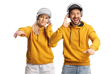 Cheerful young man and woman dancing with headphones