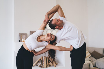 Happy couple doing acro yoga exercise together