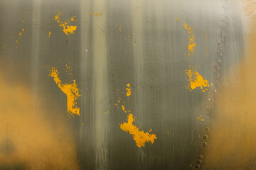 Number on a military aircraft fuselage. Texture. Old camouflage surface with exfoliated paint and rivets on a military aircraft.