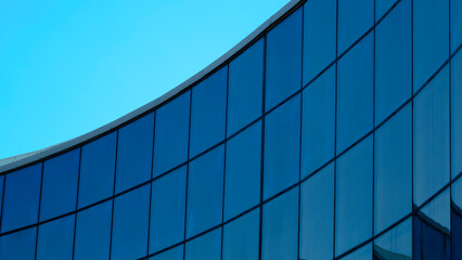 Corporate building in city, modern glass business center. view of the wall of glass, perspective to the sky
