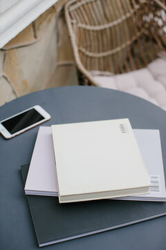Mockup image magazine book and phone at the local table in the coffee shop.