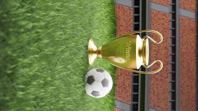 Football tournament trophy with ball on a stadium soccer field, vertical with text space