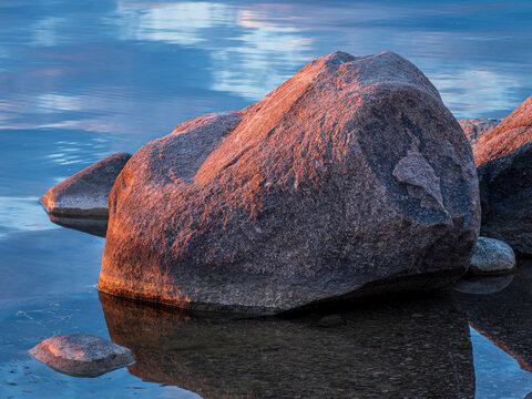 large boulders in a lake at sunrise