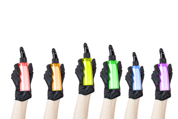 A hand with a black rubber glove holding multi-colored hair care sprays on a transparent background. Banner