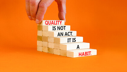 Quality is a habit symbol. Concept words Quality is not an act it is a habit on wooden blocks....