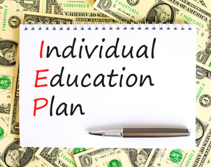 IEP individual education plan symbol. Concept words IEP individual education plan on white note on a beautiful background from dollar bills. Business IEP individual education plan concept. Copy space.