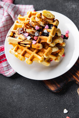 Belgian waffles or American waffles breakfast or sweet dessert banana, chocolate meal food snack on the table copy space food background rustic top view