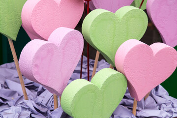 Colored wooden heart. Wood texture, painted pink, lime and purple paint.