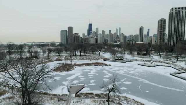 Aerial view rising over the Lincoln Park Zoo towards the downtown of Chicago, cloudy, winter day in Illinois, USA