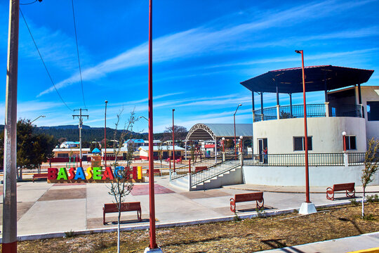 park at sunny day with kiosk and sign witht the name of the place "basaseachi" in chihuahua, Basaseachi, Chihuahua Mexico, February 02 2022