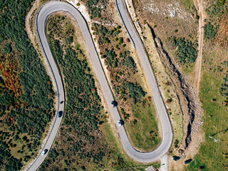 Obraz premium Aerial view of winding road. Splendid morning scene of asphalt roadway. Highway through the woodland . Traveling concept background.