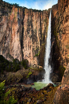 high waterfall surrounded by walls of stone and water with sulfur in basaseachi chihuahua view from down, sierra tarahumara