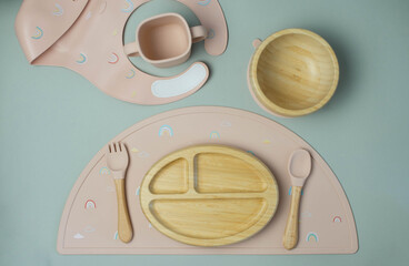 A set of children's silicone dishes. Baby feeding and nutrition concept. Top view, flat lay.