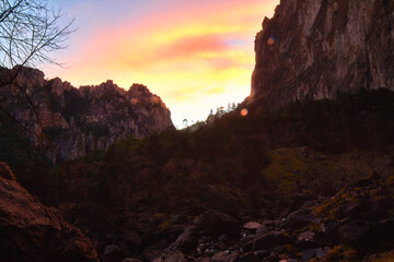 canyon at red sunset with forest and mountains around, dramatic sky in basaseachi chihuahua 