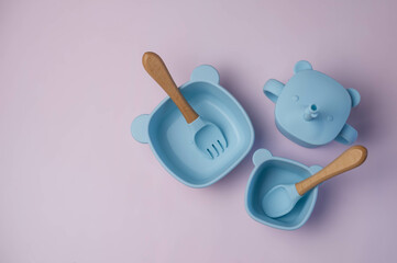 A set of children's silicone dishes. Baby feeding and nutrition concept. Top view, flat lay.