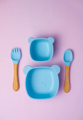 A set of children's silicone dishes. Baby feeding and nutrition concept. Top view, flat lay.