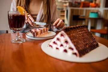 Young girl at a cafe eating cake