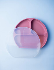 Baby silicone plate isolated on background. Baby feeding and nutrition concept. Top view, flat lay.