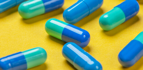 Background from pills of different colors on a bright background