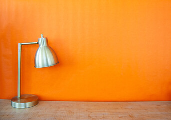isolated lamp over orange wall
