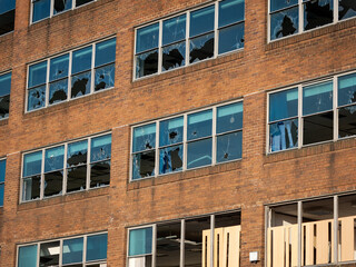 vandalism of office bloke with all its glass windows broken