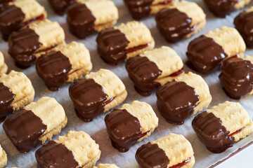 Christmas cookie filled with marmalade and dipped in chocolate