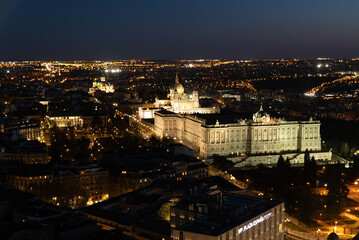 Fototapeta na wymiar Madrid, Spain. April 6, 2022: Panoramic landscape of the royal palace with blue sky and city view.