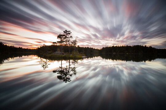 Reflections of the clouds in the lake at sunset in Nationalpark Tyresta close to Stockholm city.