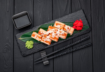 Sushi rolls with grilled salmon and pear.