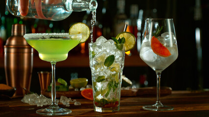 Fresh various cocktails on the bar, dark toned background