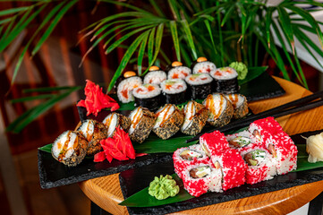 Big set of Asian food. Sushi and rolls on a dark background.