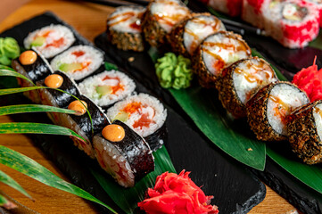 Big set of Asian food. Sushi and rolls on a dark background.