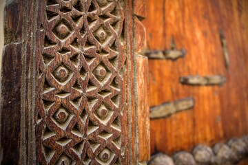Close-up view of ancient wooden door of Nizwa fort in Oman