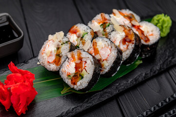 Sushi rolls with salmon, crab, shrimps and spicy sauce