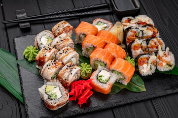 Big set of Asian food. Sushi and rolls on a dark background.