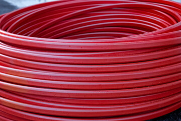 Twisted rubber red hose coiled